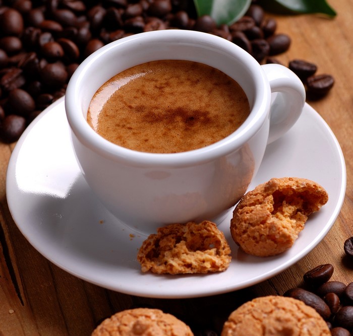 Espresso cup with cookies and coffee beans