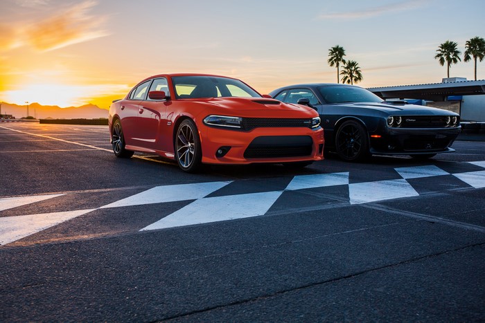 Orange Dodge Charger and Gray Dodge Challenger on Track