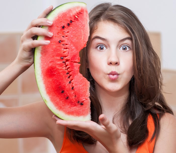 Girl holding a slice of watermelon
