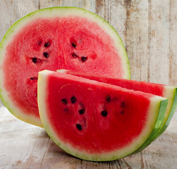 Watermelon slices on a wooden surface
