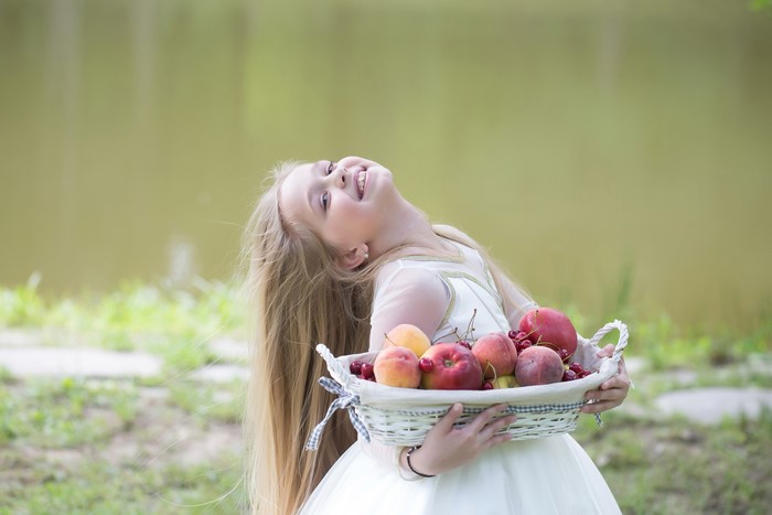 Little girl with a basket of fruit