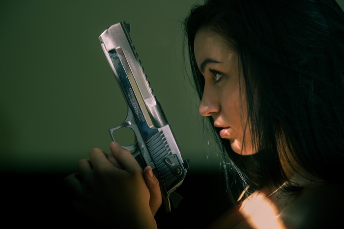 Woman holding a Desert Eagle pistol