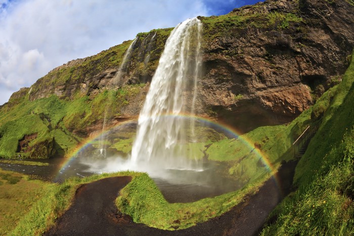Seljalandsfoss waterfall with rainbow in Iceland