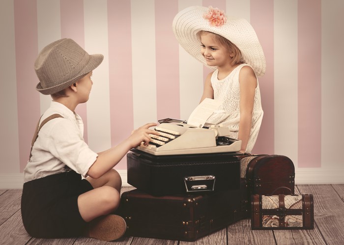 Boy and Girl with Typewriter and Suitcases
