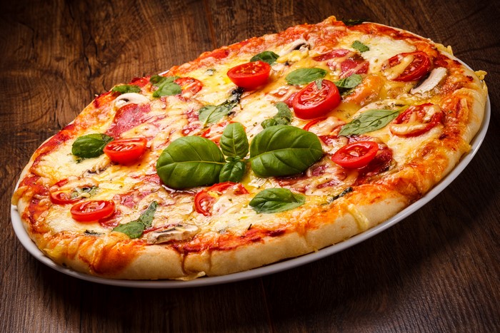 Pizza with tomatoes and basil