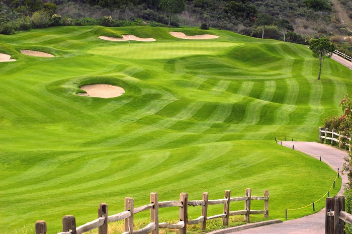 Golf course with sand traps and rolling green hills