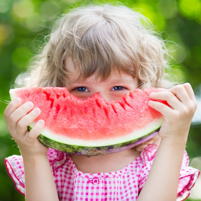 Little girl eating watermelon