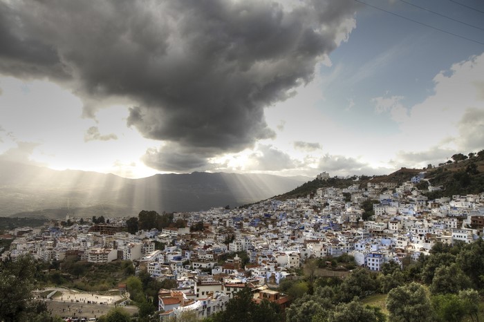 Chefchaouen, Morocco, city on a hill under stormy sky