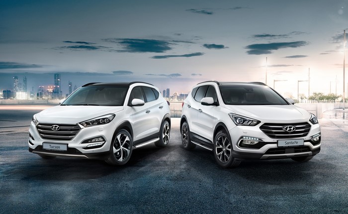 Two white Hyundai Tucson and Santa Fe cars