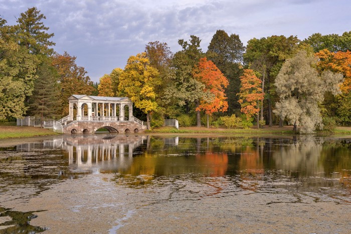 Marble Bridge over pond in Pavlovsk Park, St. Petersburg, Russia during autumn