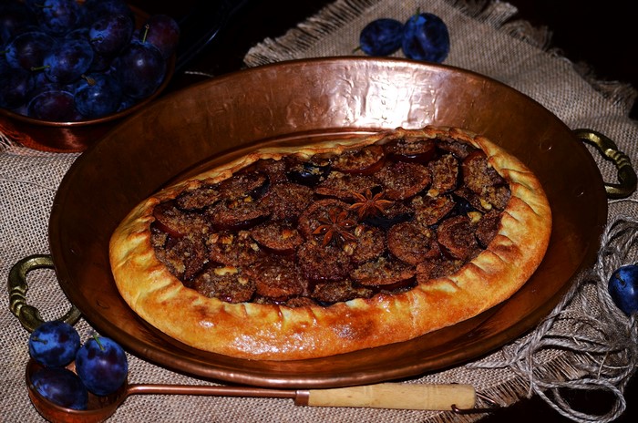 Plum galette in a copper pan
