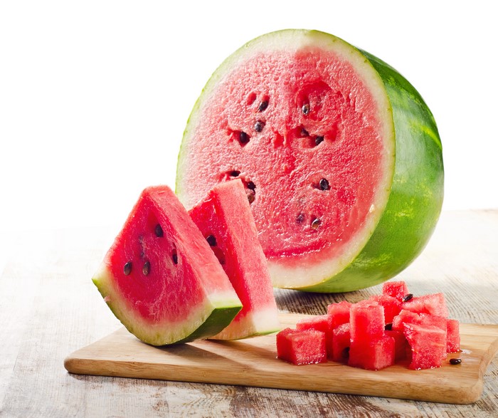 Watermelon slices and cubes on a cutting board