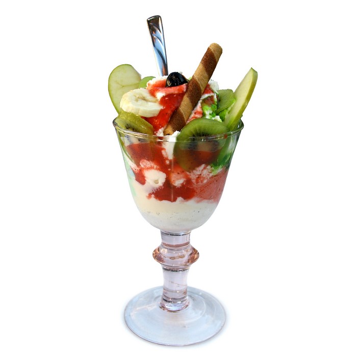 Ice cream sundae with fruit and a wafer stick