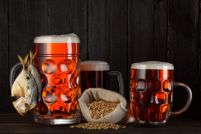 Beer mugs with dried fish and grains