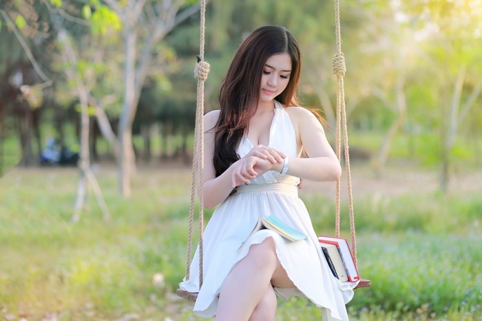 4K Serene Moment of Woman Sitting on Swing