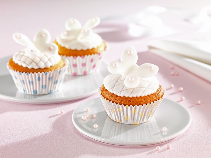 Three cupcakes with butterfly decorations