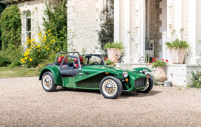 Green Caterham 7 Sprint parked in front of a house