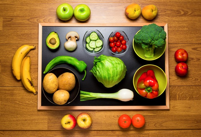 Still-life of fruits and vegetables on a blackboard