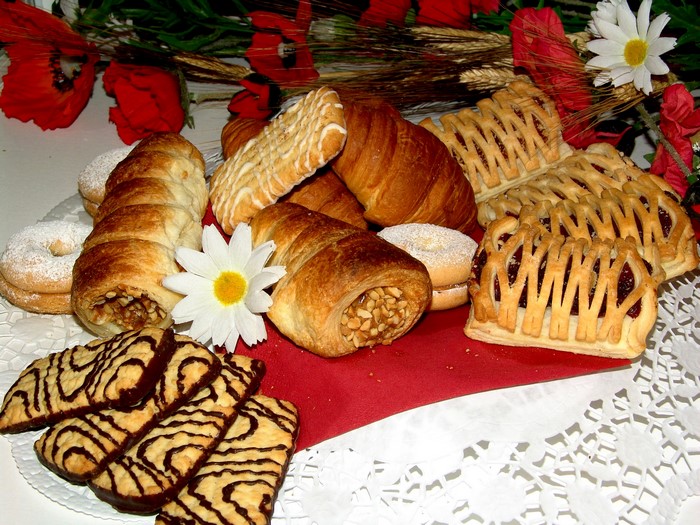 Assortment of pastries, cookies, and croissants with poppies