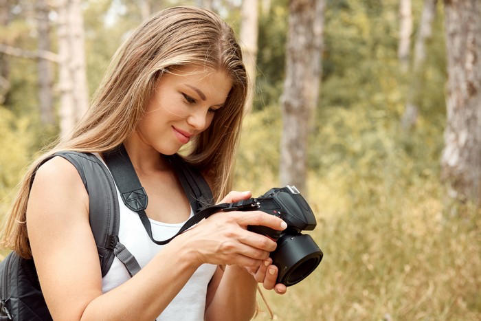 Woman with camera in forest