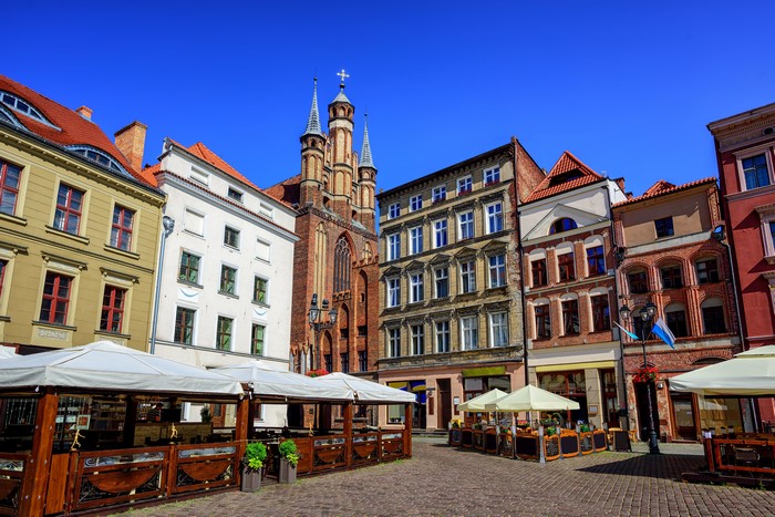 Torun, Poland street with historic buildings and outdoor cafes