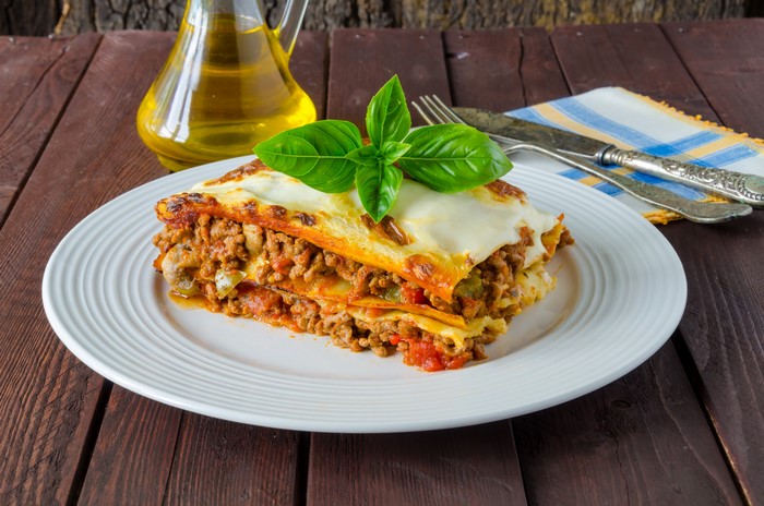 Lasagne on a plate with basil garnish