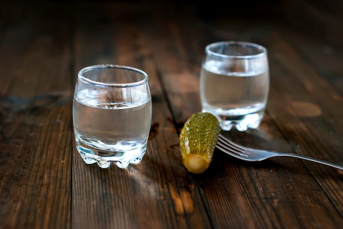 Vodka shots with a pickle and fork