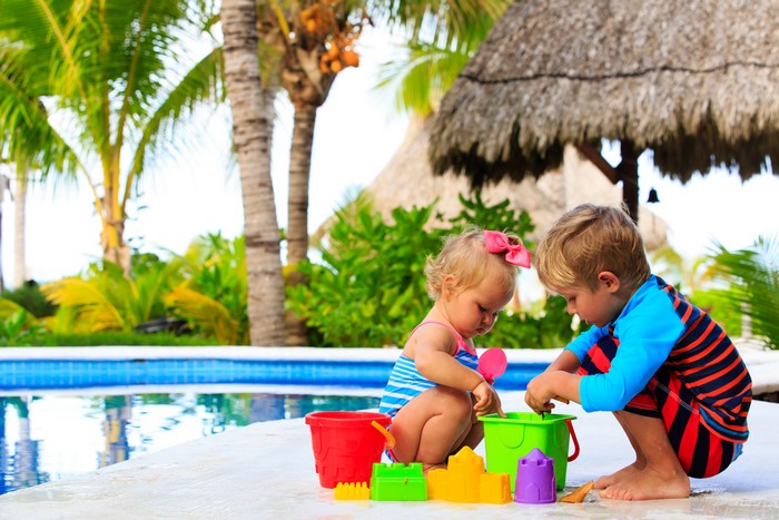 Children playing with toys by the pool
