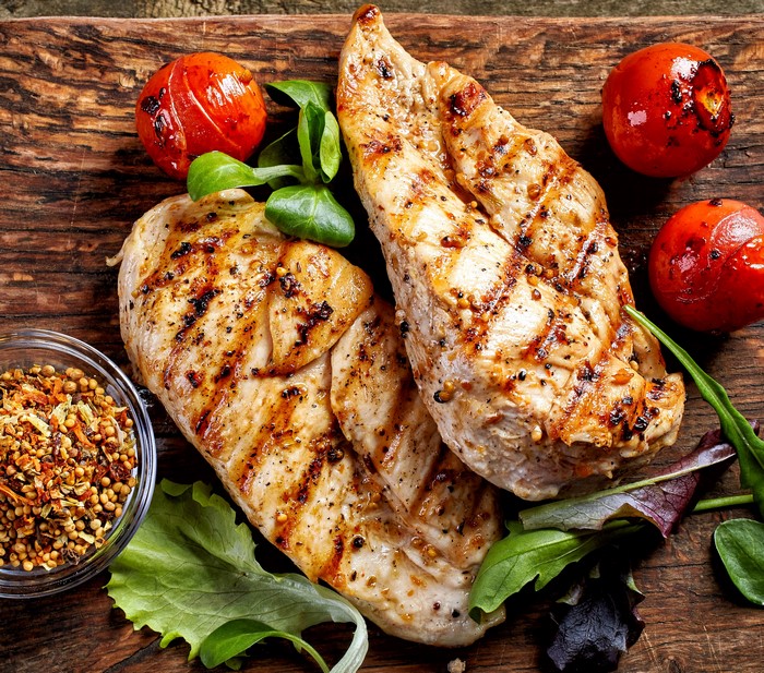 Grilled chicken breasts with tomatoes and spices