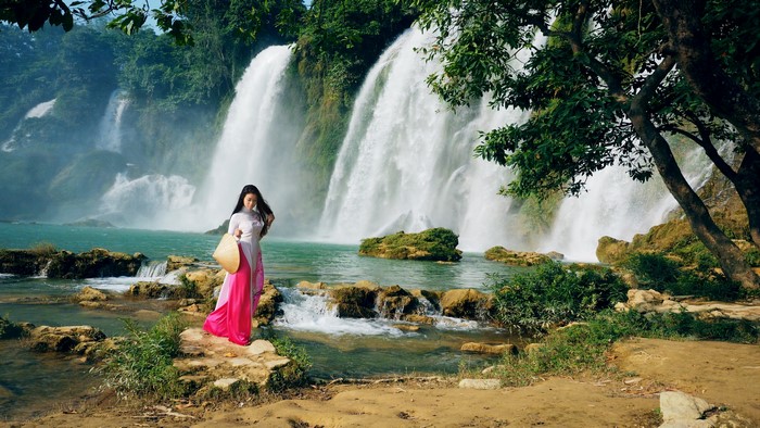 Woman in traditional dress at Ban Gioc Waterfall