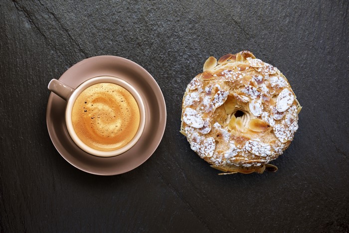 Coffee and Almond Pastry on Dark Surface