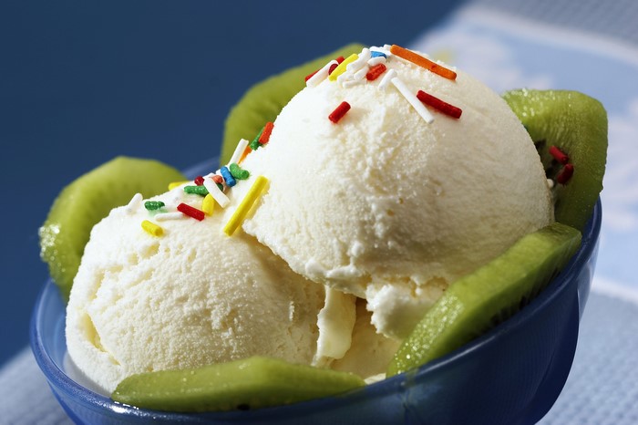 Vanilla ice cream with kiwi slices and sprinkles