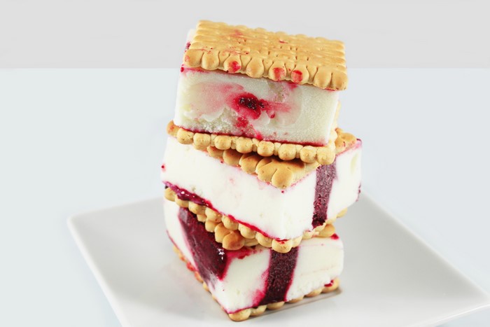 Three ice cream sandwiches stacked on a plate