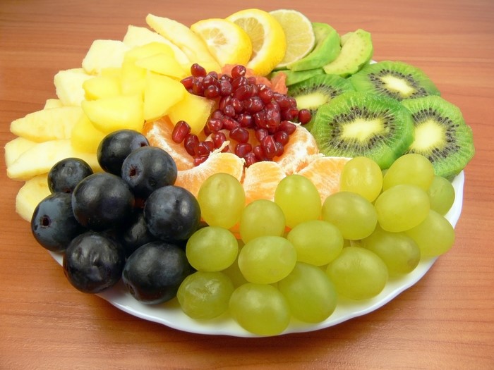 Fruit platter with grapes, kiwi, pomegranate, and citrus