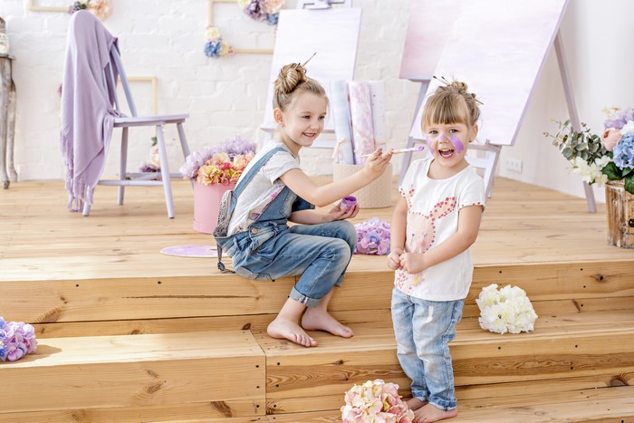 Two little girls painting faces