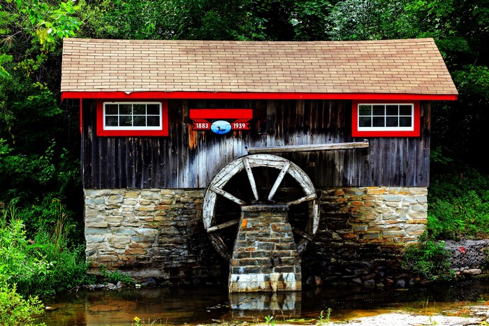 Watermill with a water wheel and stone foundation