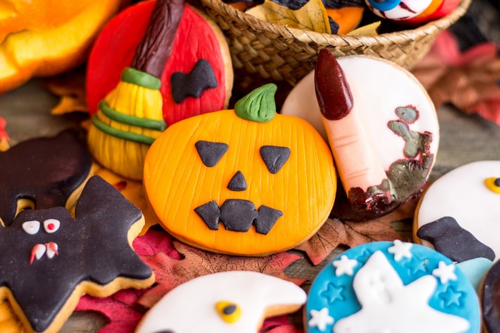 Halloween cookies with pumpkin, bat, ghost, and witch broom designs