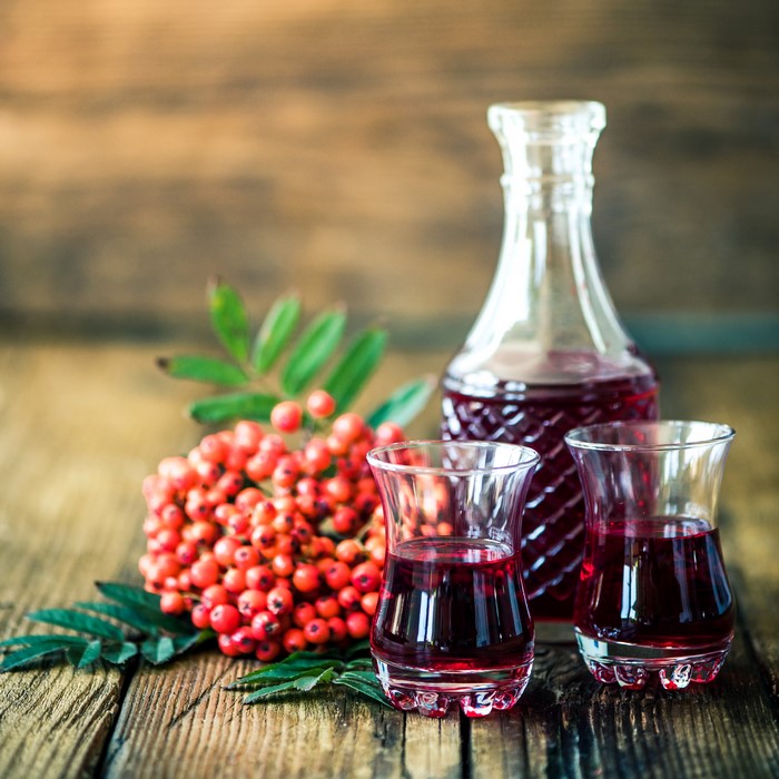 Rowan Berry Liqueur in Glasses and Bottle