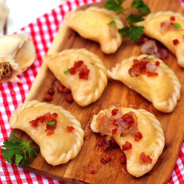 Pierogi with bacon and parsley on a wooden board