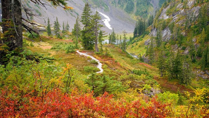 Autumn mountain landscape with a hiking trail and lake