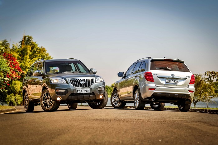 Two metallic Lifan X60 BR-spec SUVs on a road