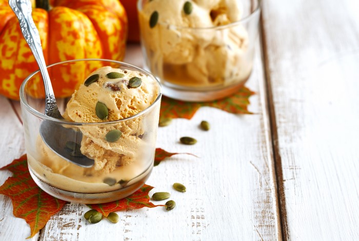 Pumpkin ice cream with pumpkin seeds and autumn leaves