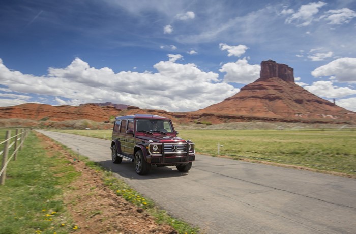 Mercedes-Benz G 550 driving on a road in a desert landscape