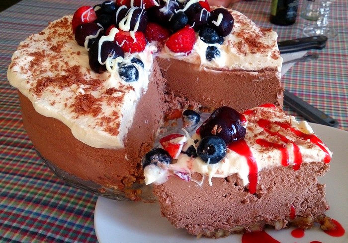Chocolate mousse cake with berries and whipped cream