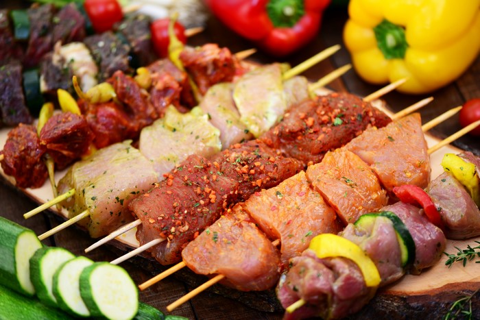 Assortment of raw meat and vegetable skewers