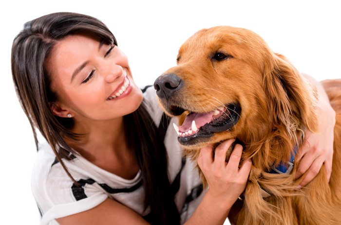Woman hugging a golden retriever dog