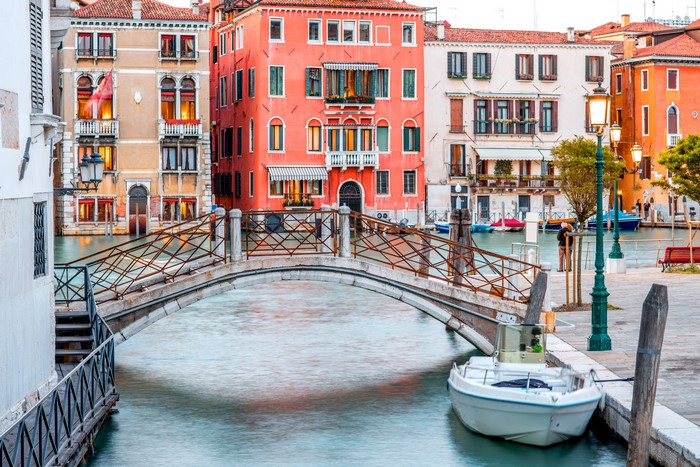 Venice canal with bridge and motorboat