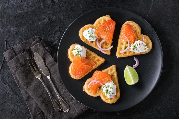 Heart-shaped waffles with salmon and cream cheese