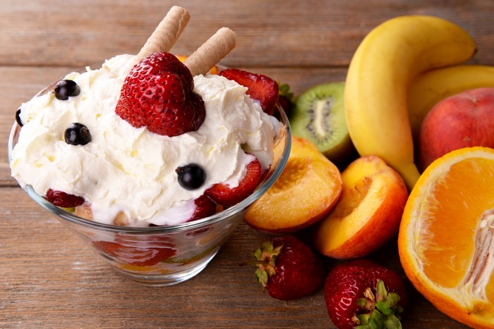 Fruit salad with cream and wafer sticks