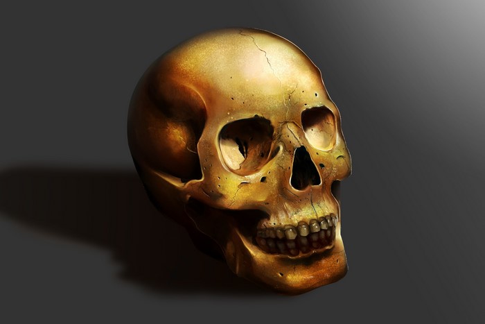 Golden skull with cracks on a dark background